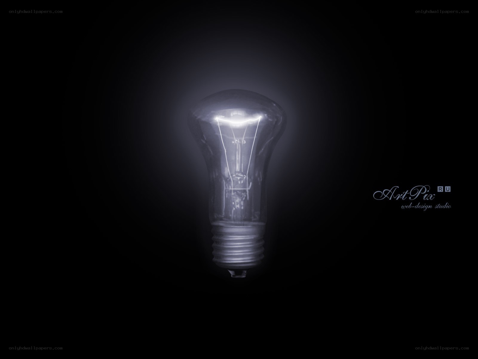 glowing light bulb in darkness