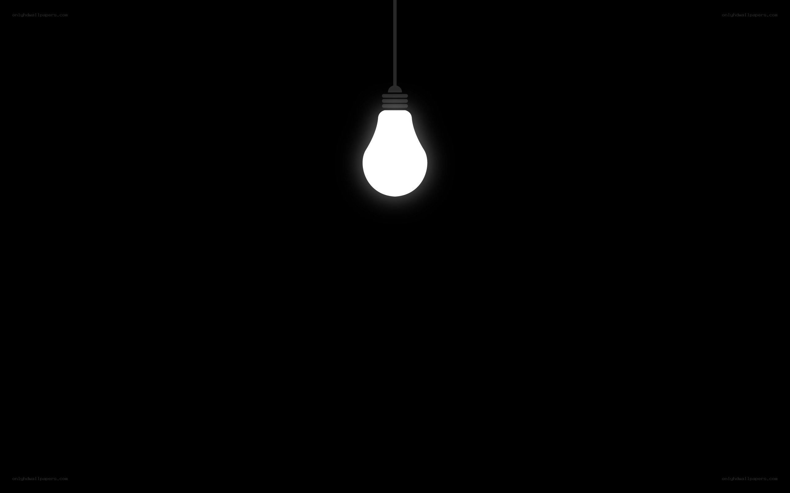 glowing light bulb in darkness