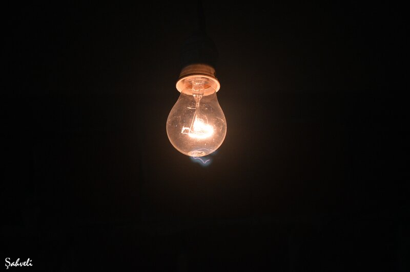 glowing light bulb in darkness