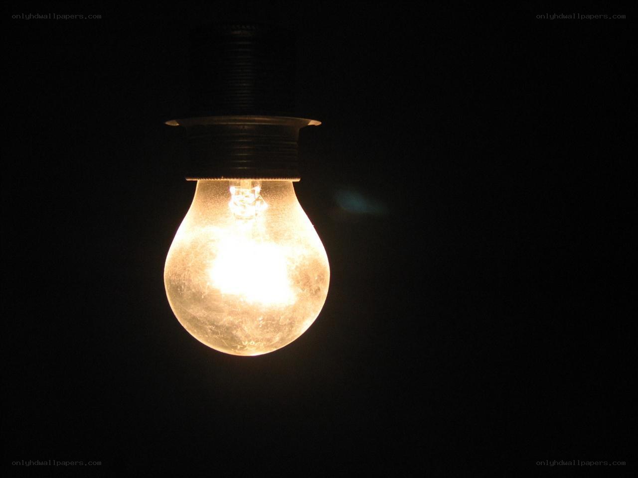 glowing light bulb in darkness