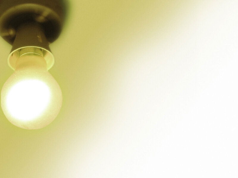 glowing light bulb on ceiling