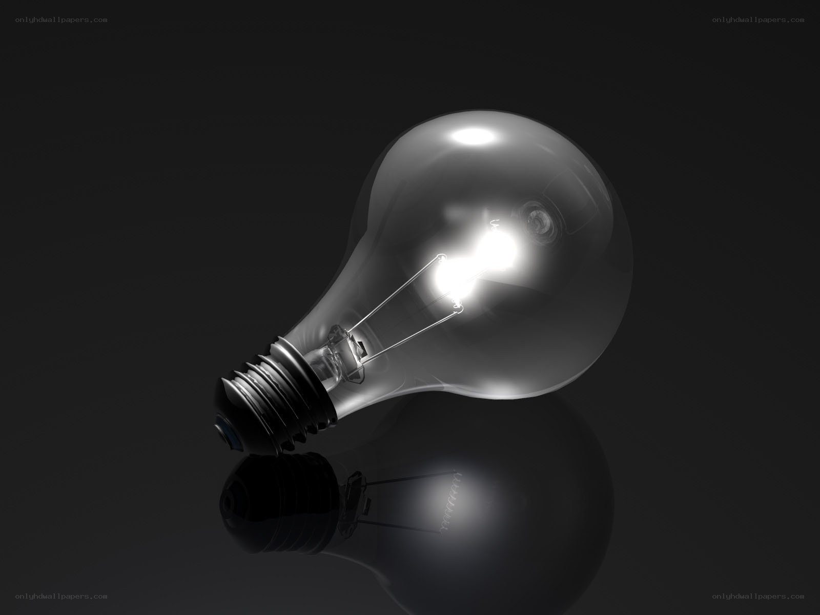 glowing light bulb on dark surface