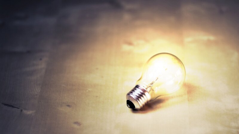 glowing light bulb on wood