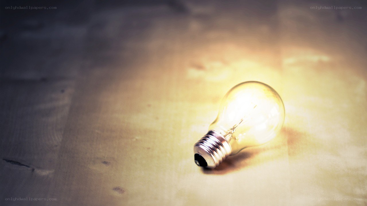glowing light bulb on wood