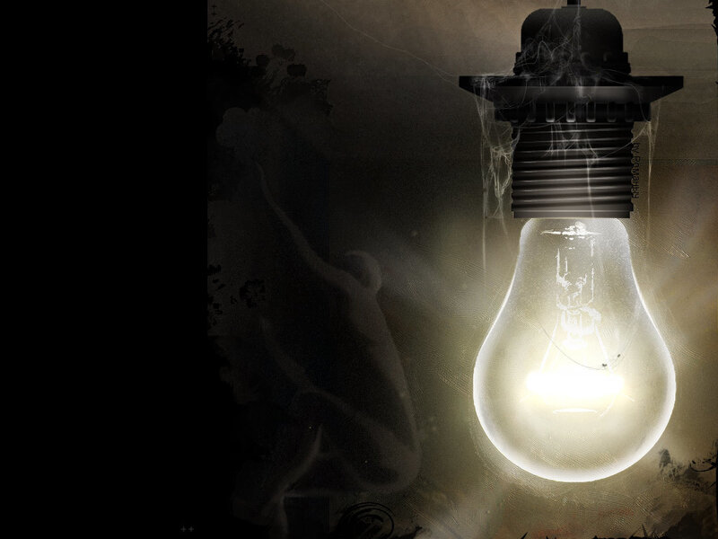 glowing light bulb with ghostly figure
