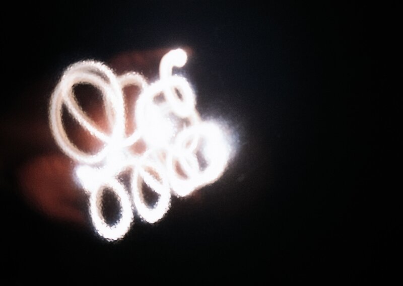 glowing light trails in darkness