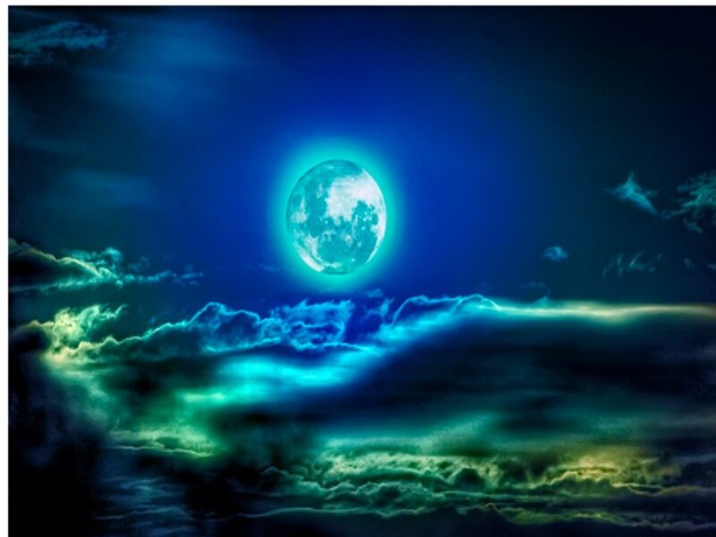 glowing moon over clouds