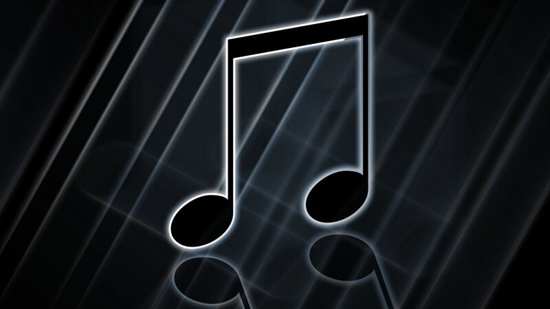 glowing music note on dark background