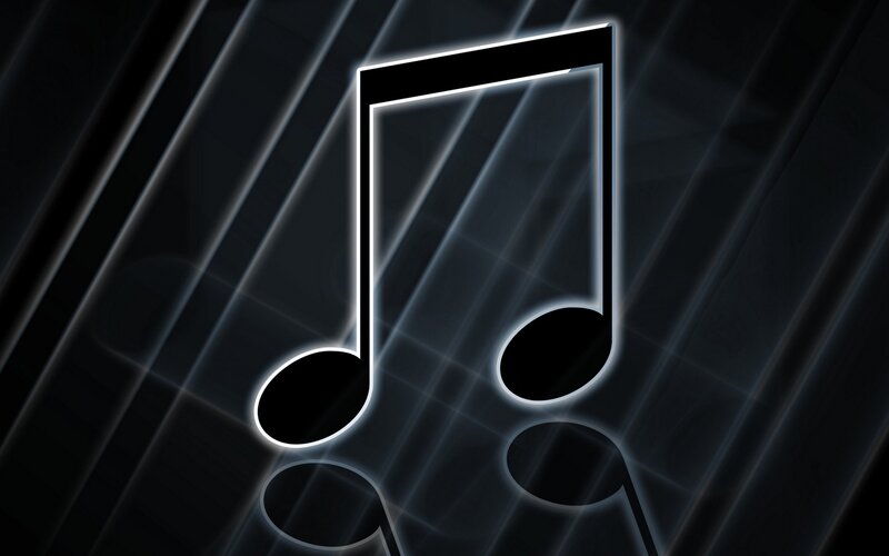 glowing music note on dark background