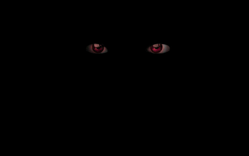 glowing red eyes in darkness