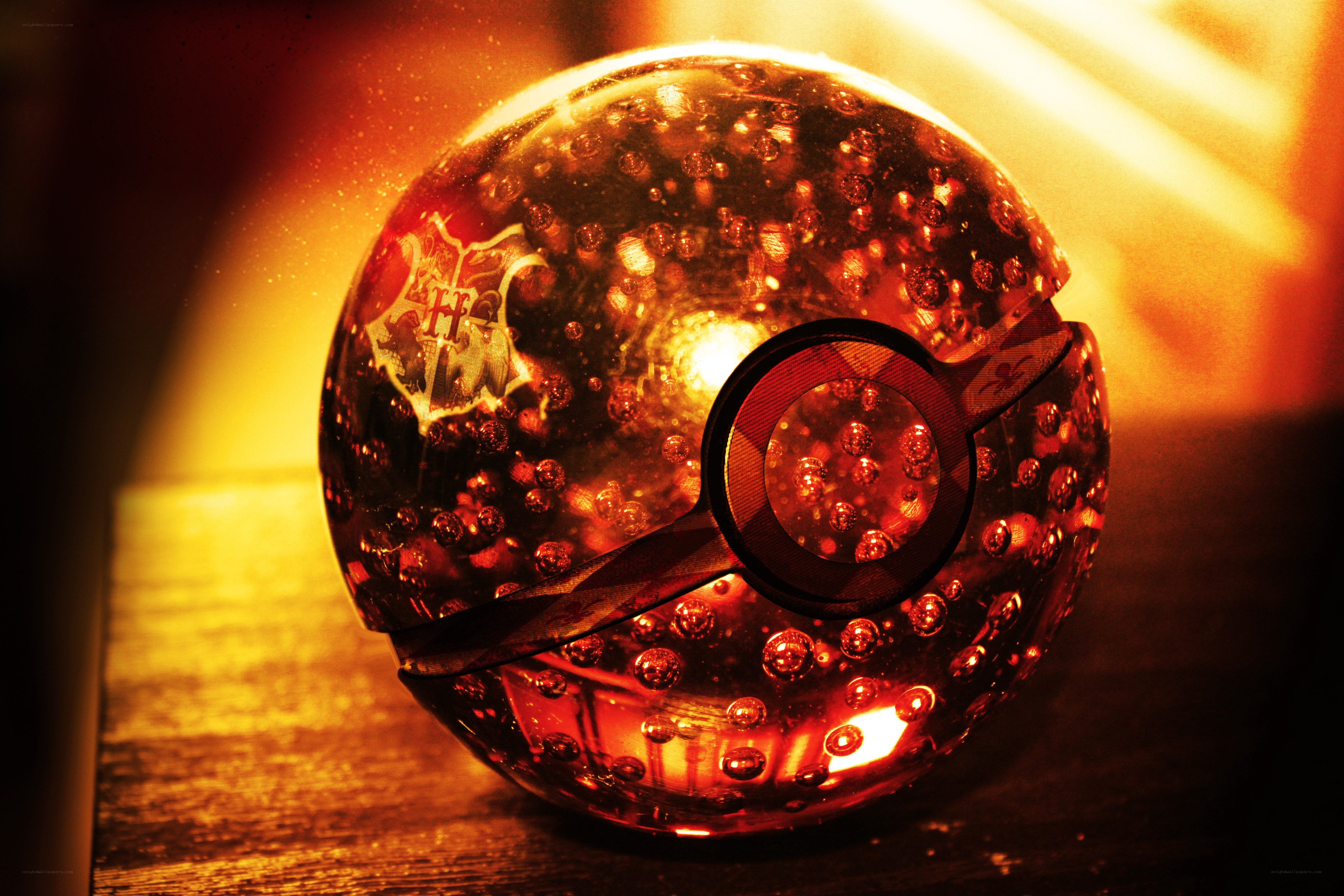 glowing red pokeball with hogwarts crest
