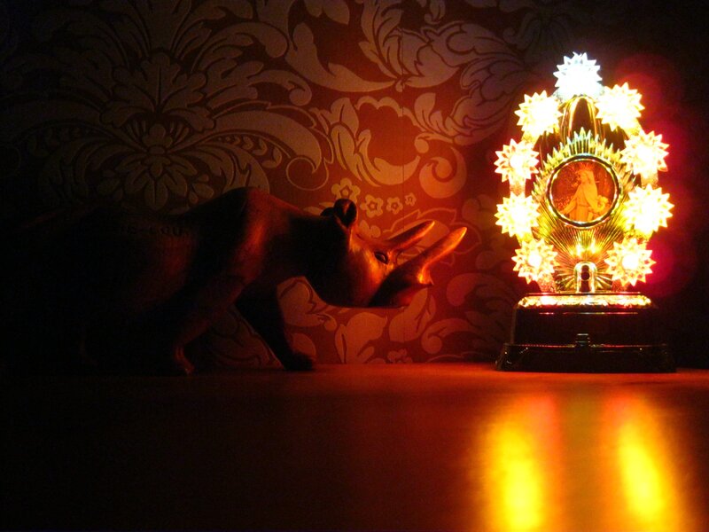 Glowing religious statue and rhino figure