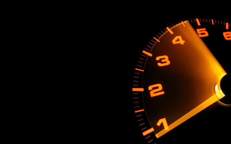 glowing speedometer in darkness