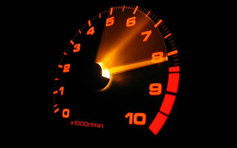 glowing tachometer in darkness