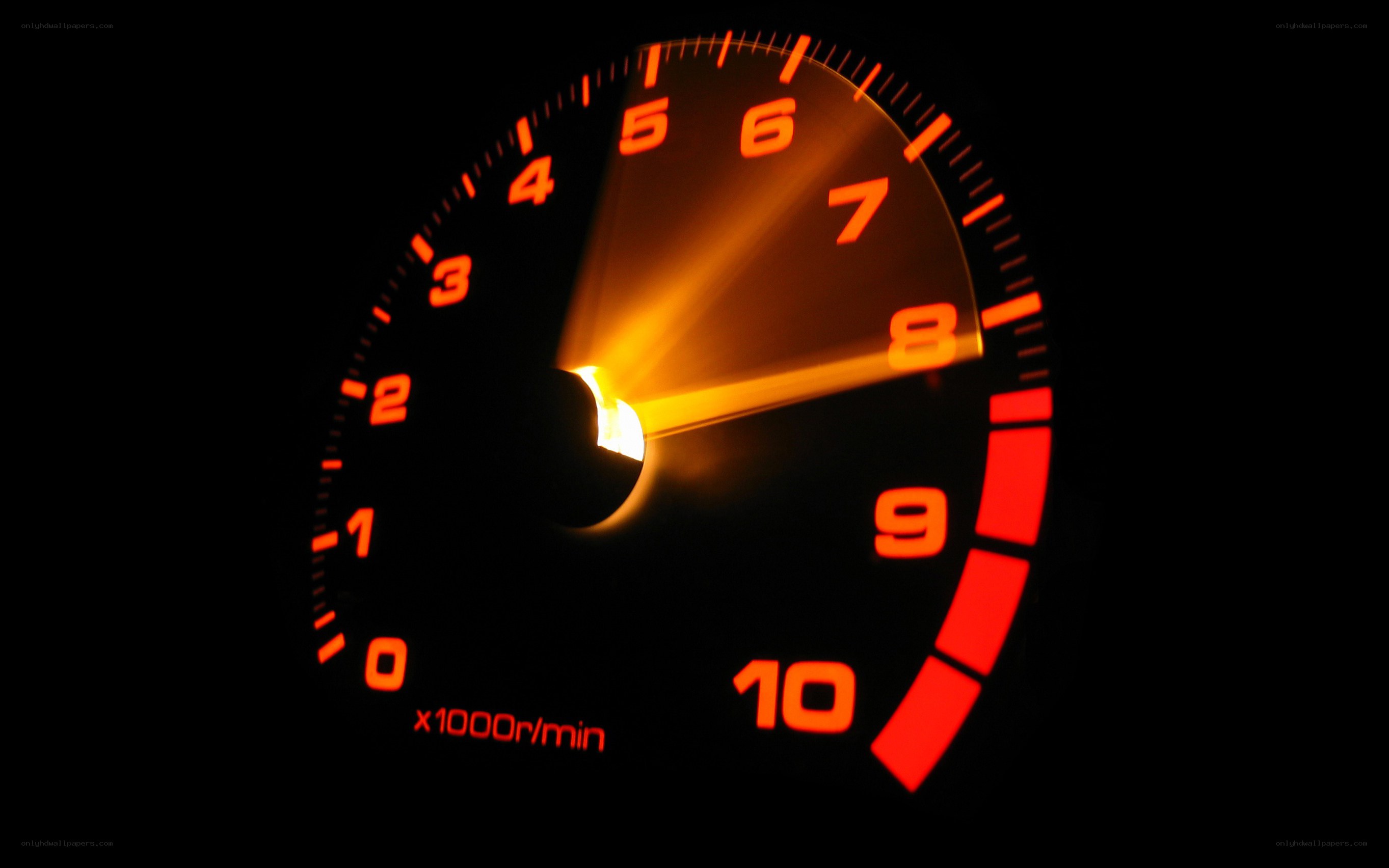 glowing tachometer in darkness