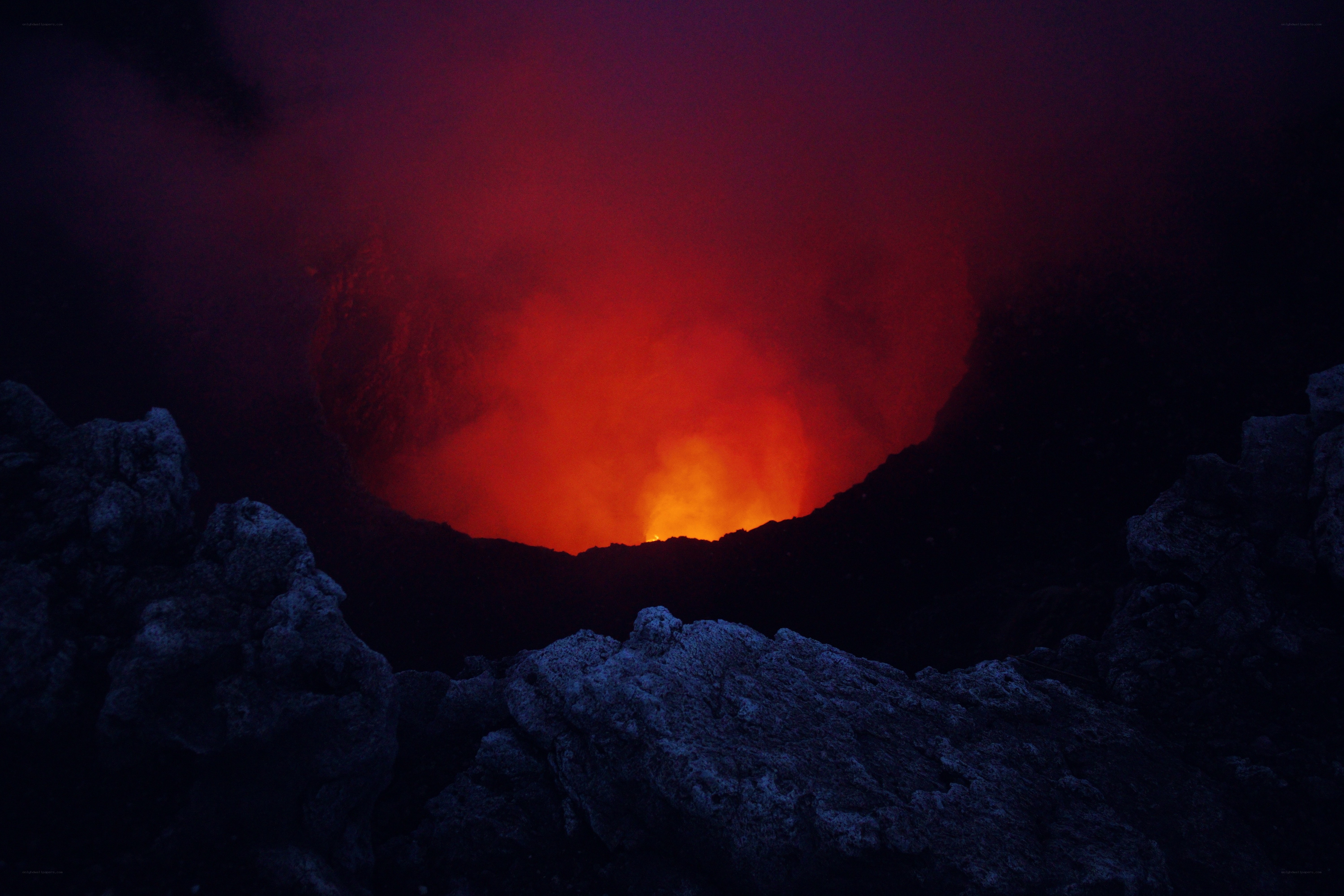 Glowing volcanic crater at night