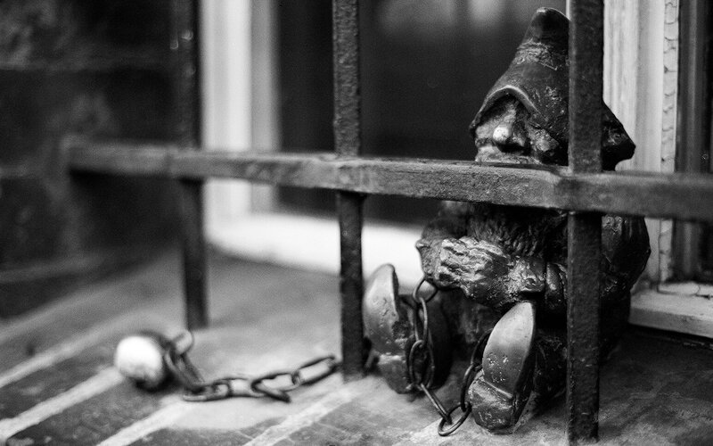Gnome in chains behind bars