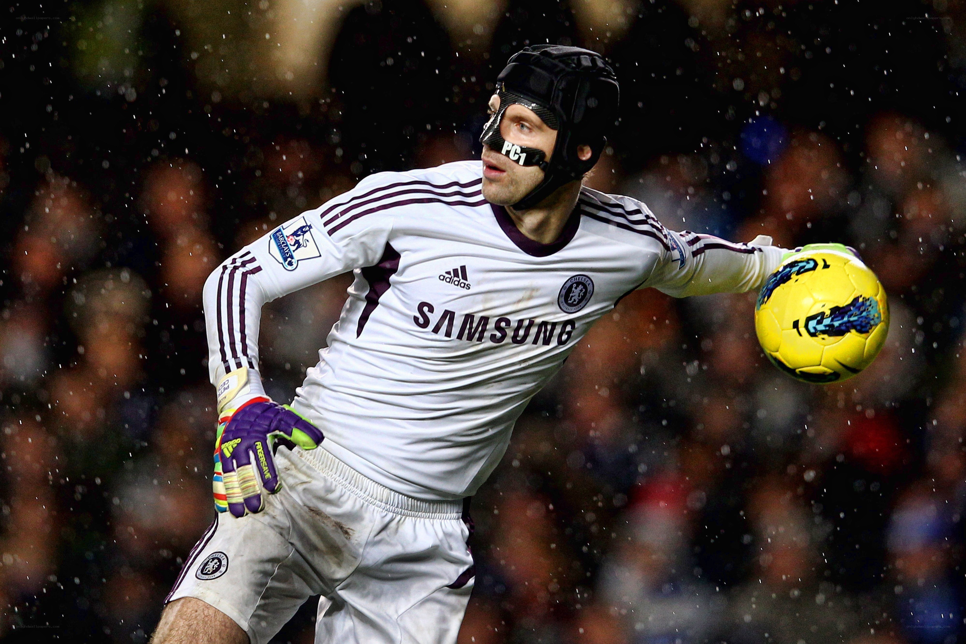 goalkeeper catching ball in rain