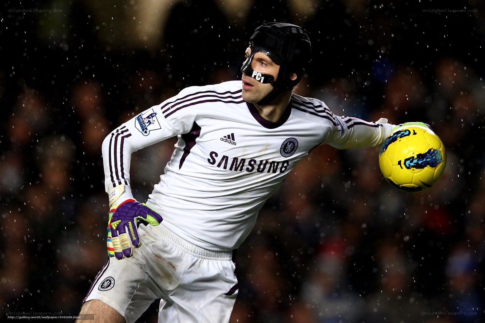 goalkeeper catching ball in rain
