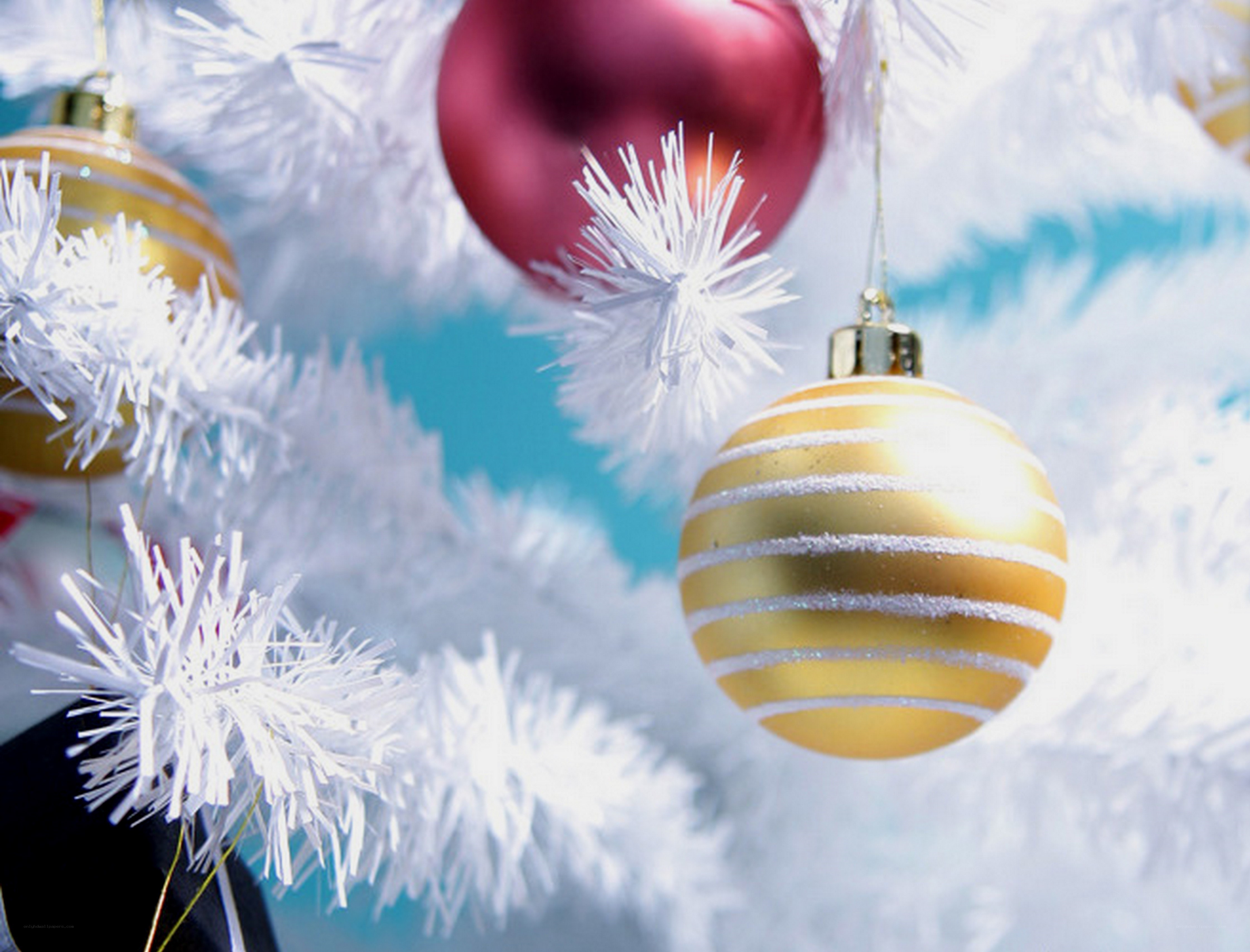 Gold and red ornaments on white tree