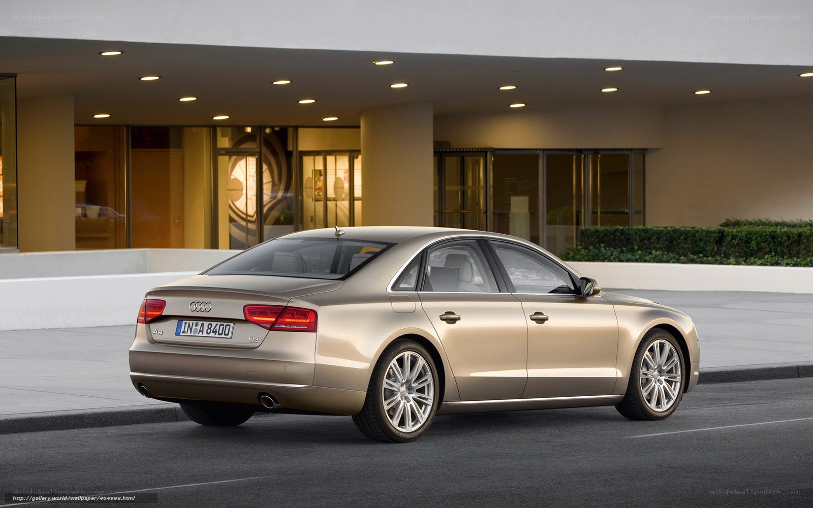 Gold Audi A8 parked outside building