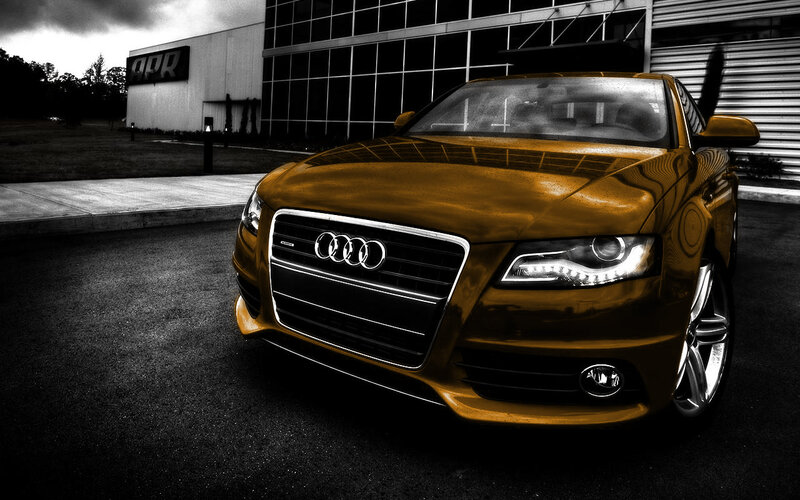 Gold Audi car in front of building
