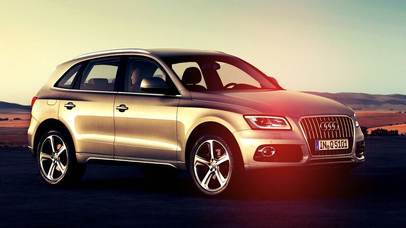 Gold Audi Q5 in a scenic landscape
