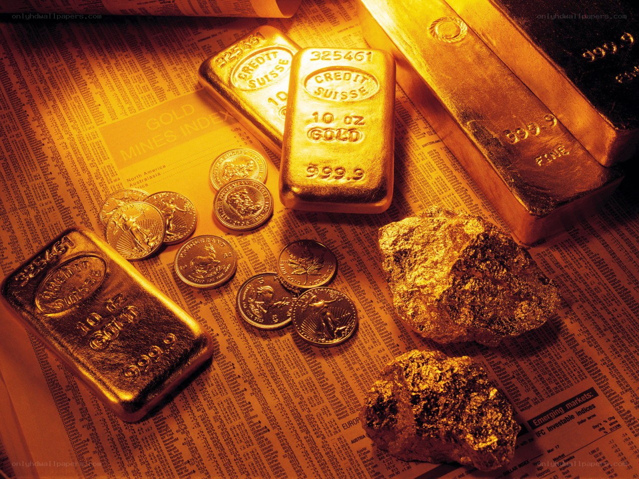 Gold bars and coins on newspaper