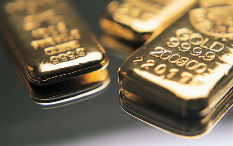Gold Bars on Reflective Surface — Dramatic