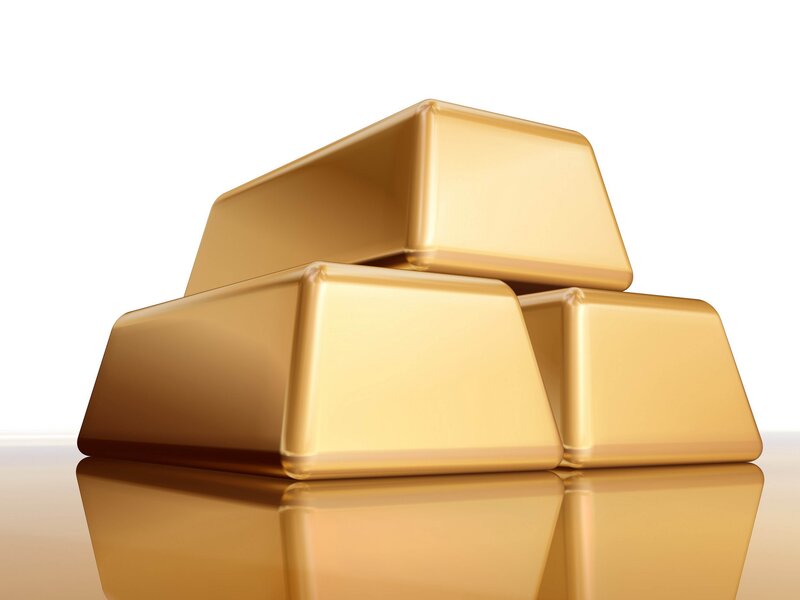 gold bars on reflective surface