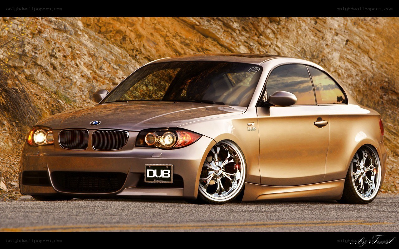 gold BMW coupe on road
