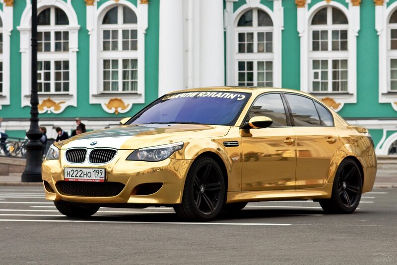 Gold BMW M5 on city street