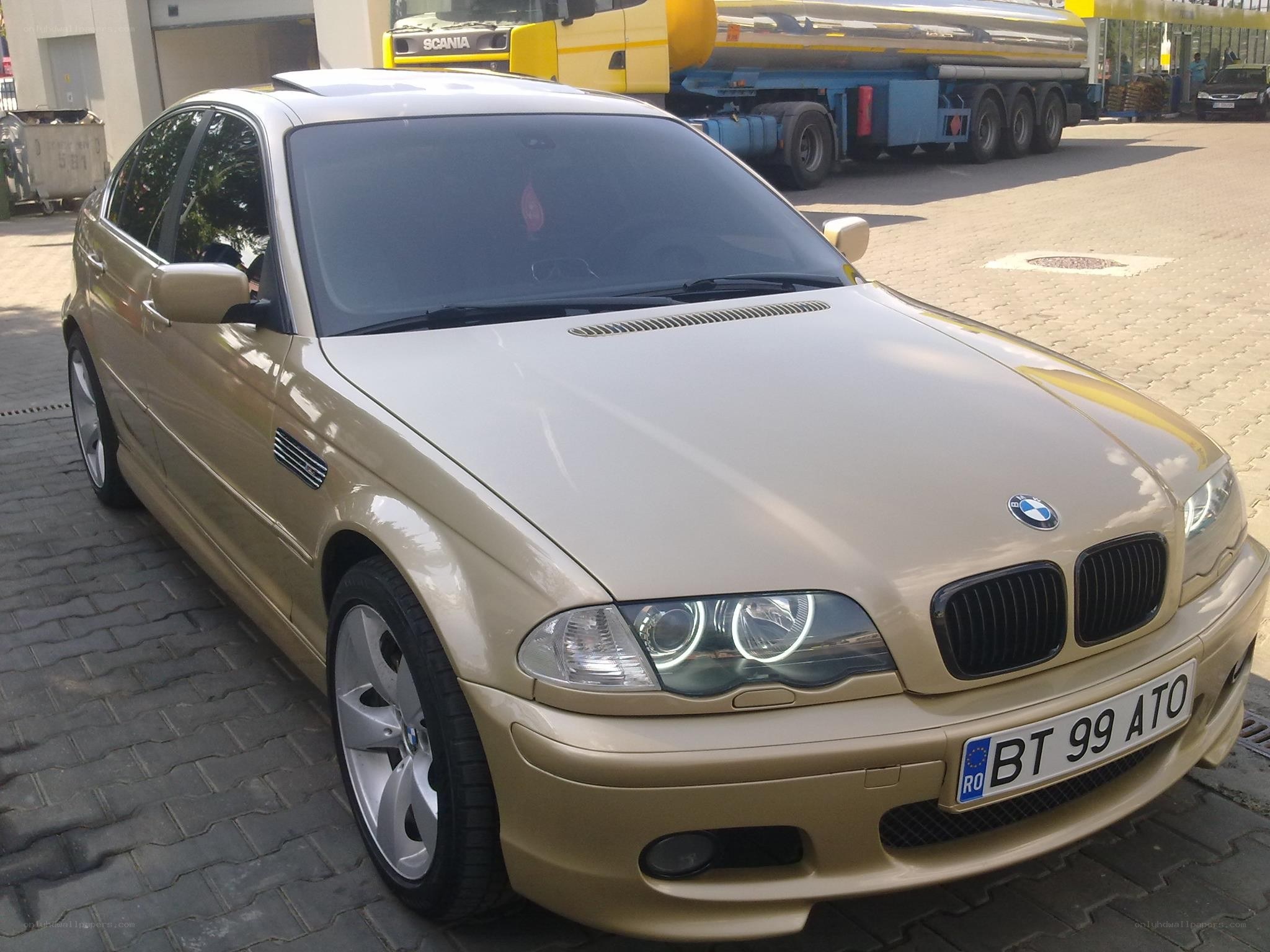 gold BMW sedan parked