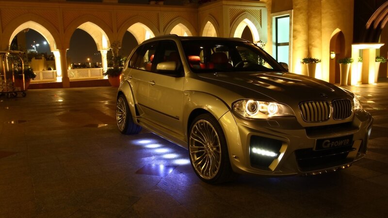 Gold BMW SUV at night
