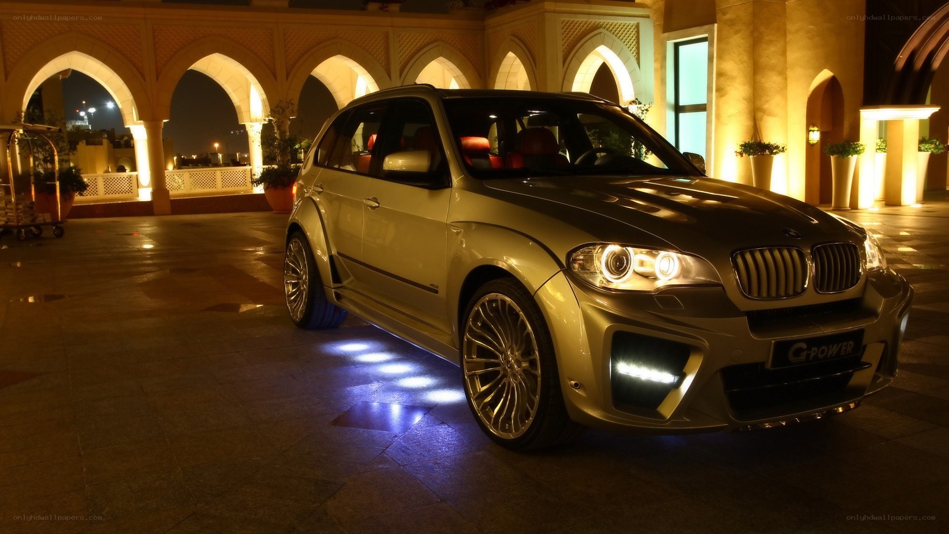 Gold BMW SUV at night
