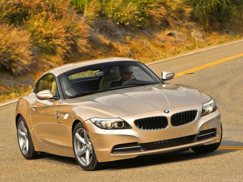 gold bmw z4 driving on road