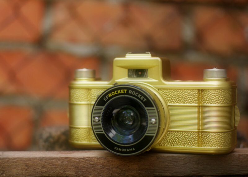 Gold Camera on Wood
