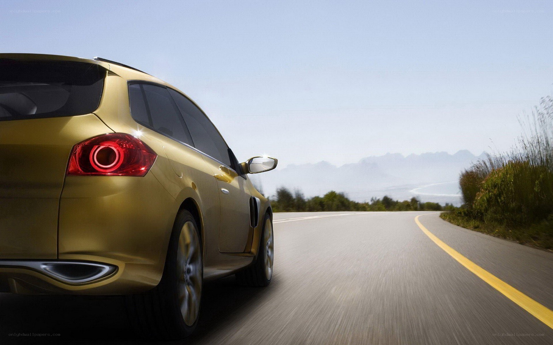 Gold car on a winding road