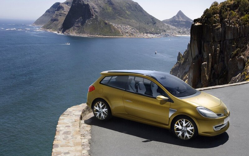 Gold car on coastal road