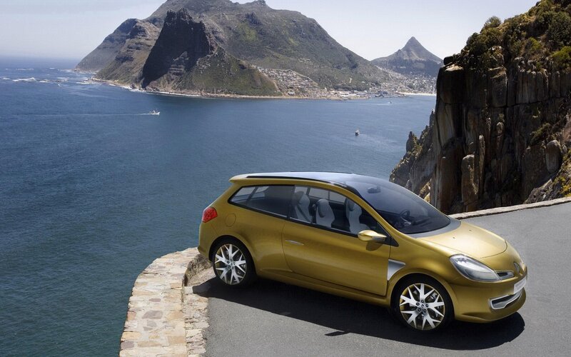 Gold car on coastal road