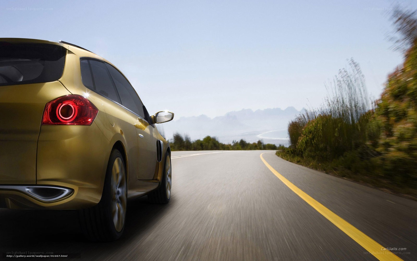 Gold car on winding road