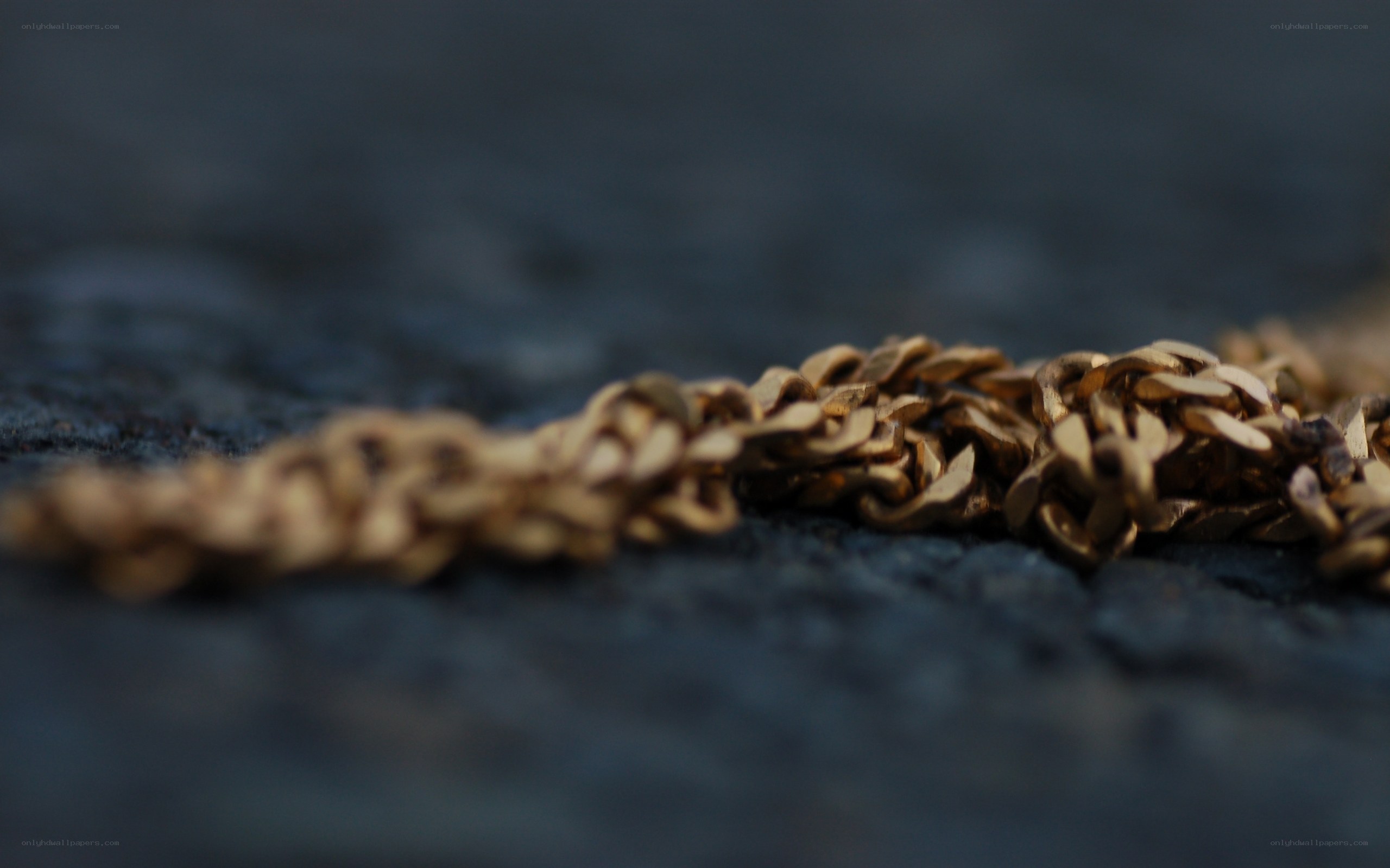 gold chain on dark surface