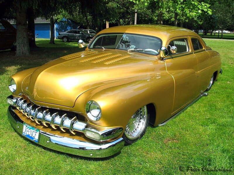 gold classic car on grass