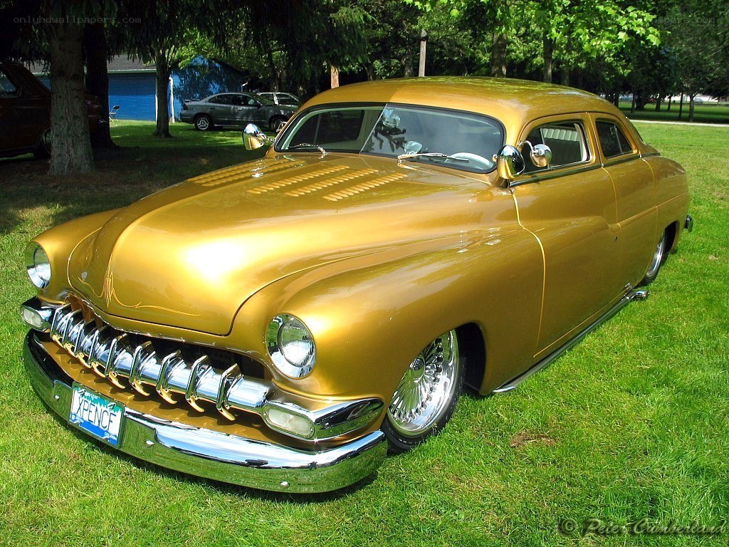 gold classic car on grass