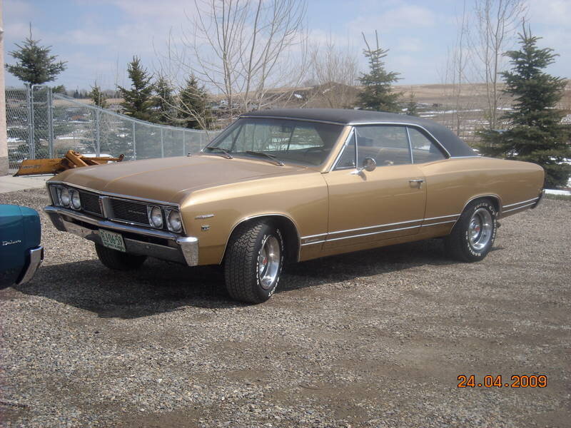 gold classic car on gravel