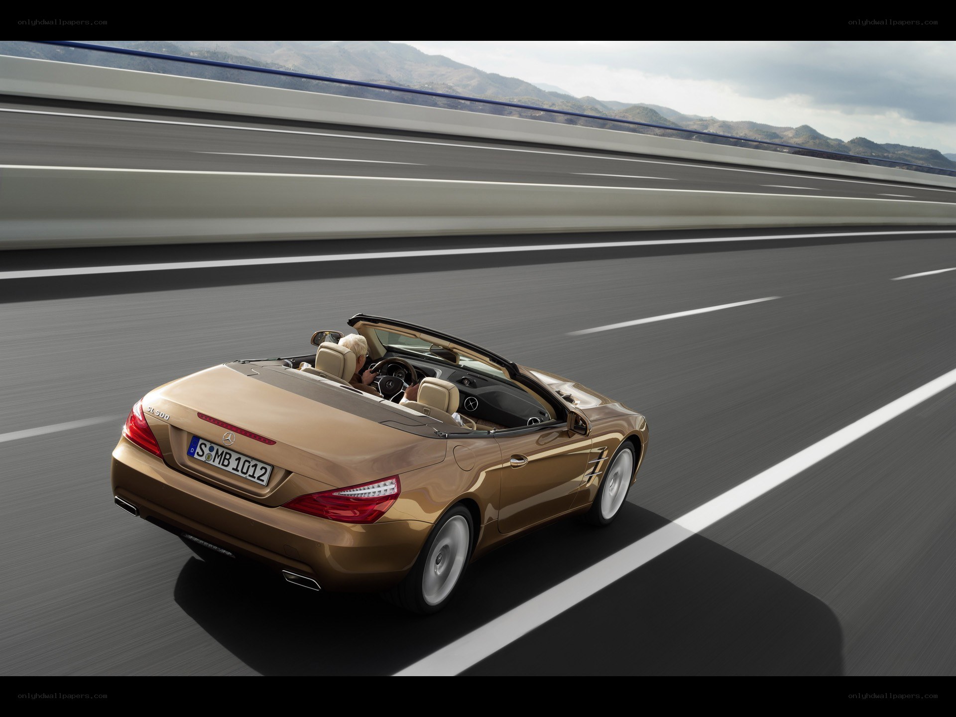 Gold convertible on highway
