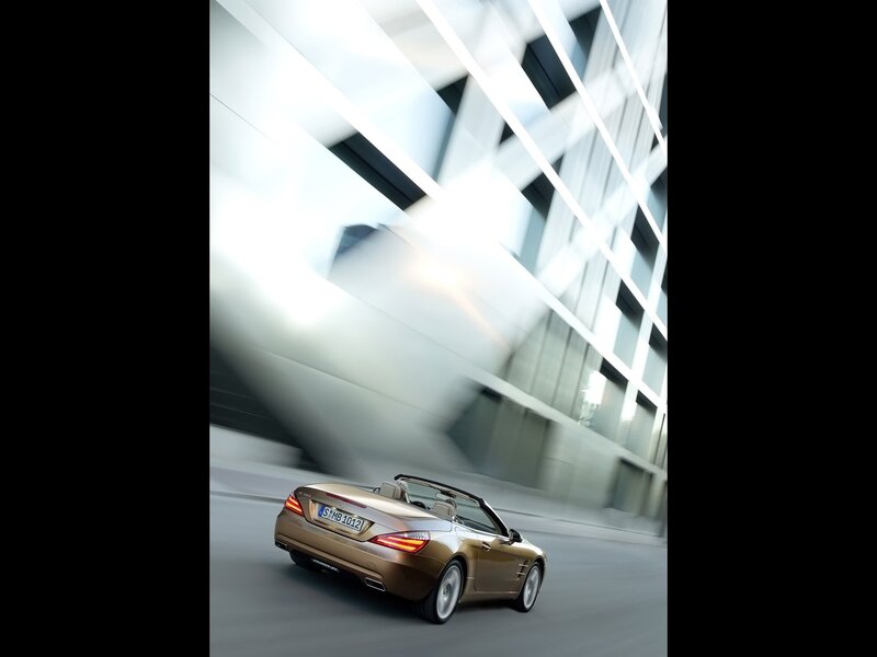 Gold convertible sports car in motion