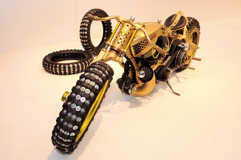 Gold custom motorcycle with spiked tires