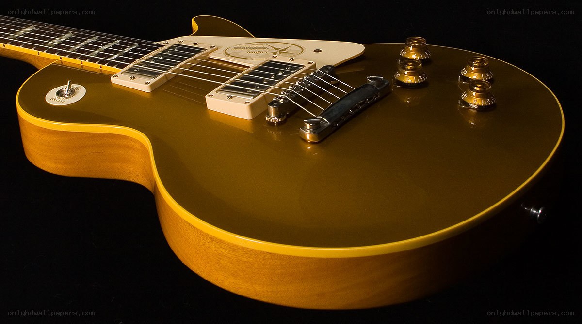 gold electric guitar