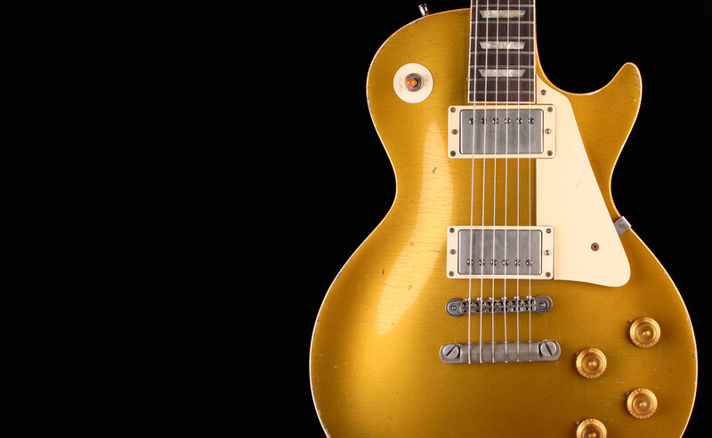 gold electric guitar